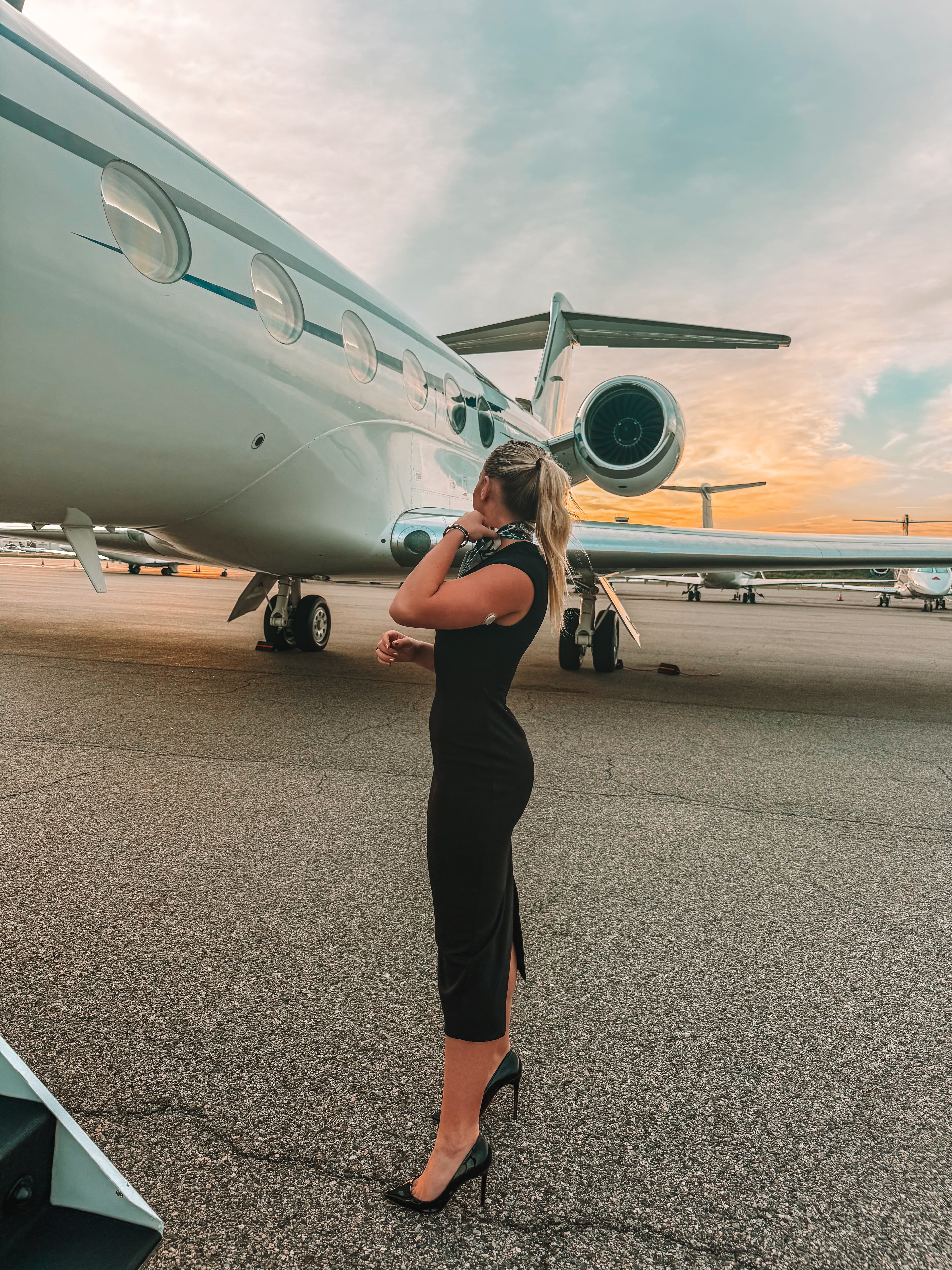 Mercedes seated inside a private jet cabin as a corporate flight attendant